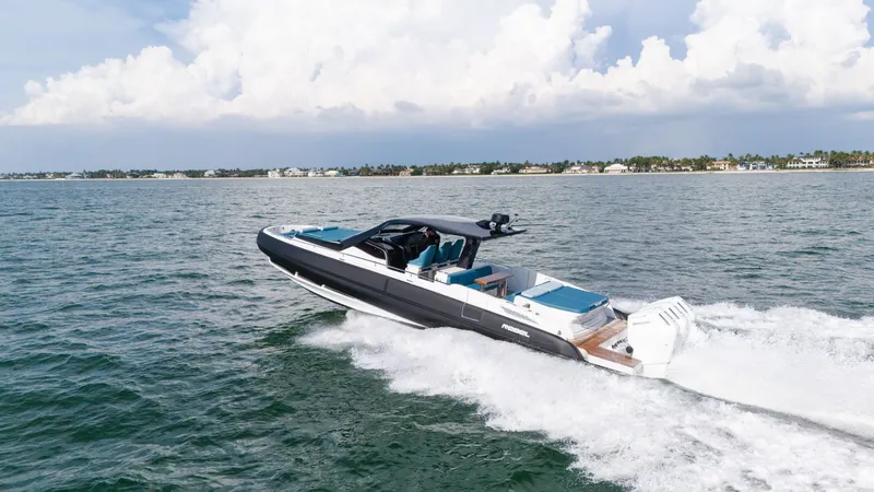 Slide: The Image of The image shows a modern speedboat cruising on the water, with a coastline in the background. - 14