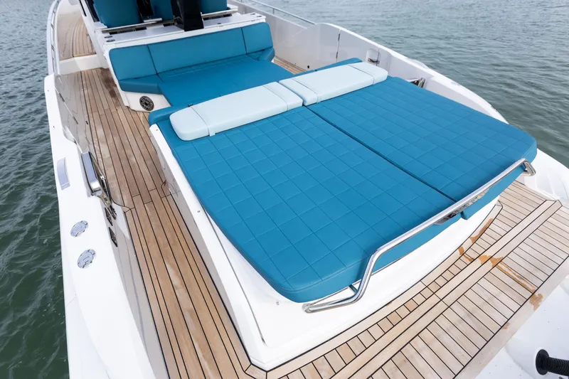 Slide: The Image of The image shows the deck of a 2025 SACS Rebel 47 with blue cushions. - 25