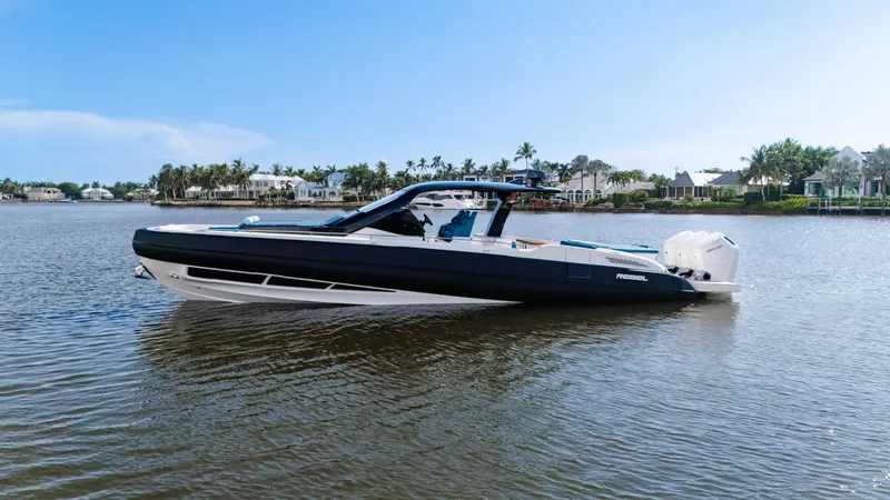 The Image of 2025 SACS Rebel 47 on calm water, featuring sleek design and elegant black and white paint. - 0