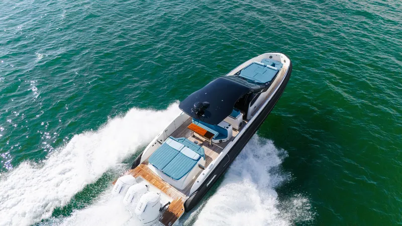 Slide: The Image of 2025 SACS Rebel 47 speeding over water with sleek design and luxurious seating. - 16