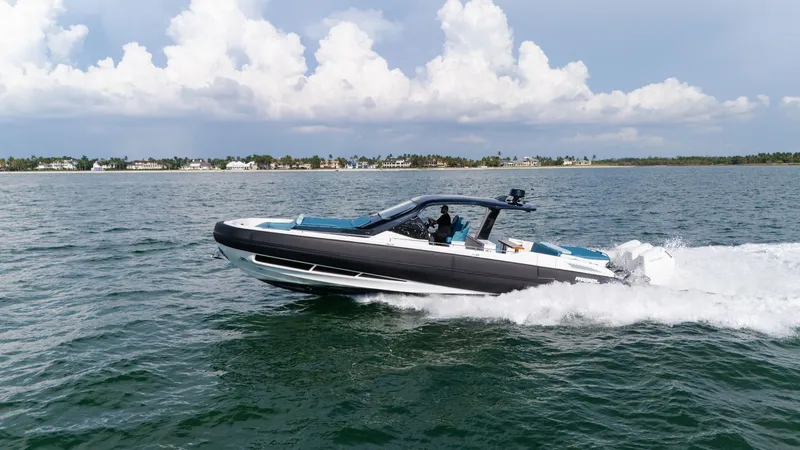 Slide: The Image of 2025 SACS Rebel 47 cruising on the water, featuring sleek design and luxurious interior. - 15