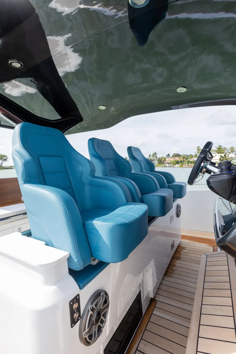 Slide: The Image of The image shows the blue seats of a 2025 SACS Rebel 47 boat. - 28
