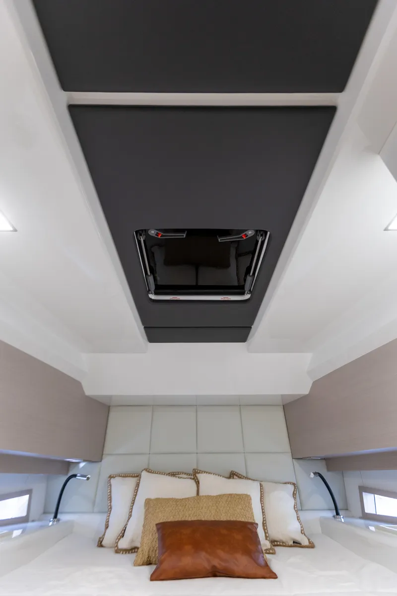 Slide: The Image of Interior of the SACS Rebel 47 featuring a cozy bed and modern accents. - 47