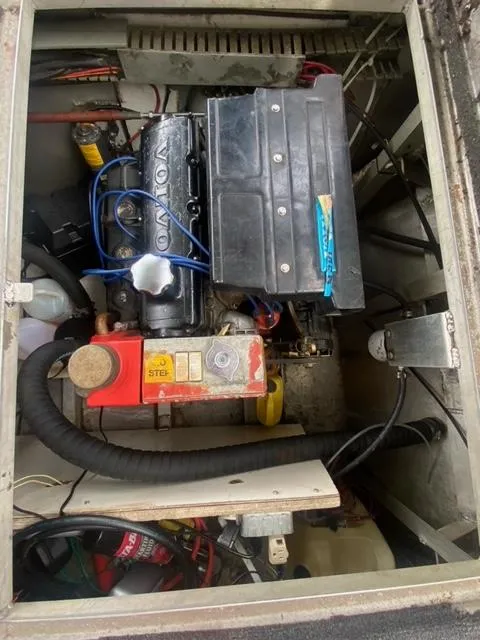 Slide: The Image of Engine compartment of a 1985 Arc houseboat, featuring a Volvo engine. - 20