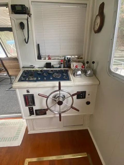 Slide: The Image of 1985 Arc houseboat control panel with steering wheel and gauges. - 6