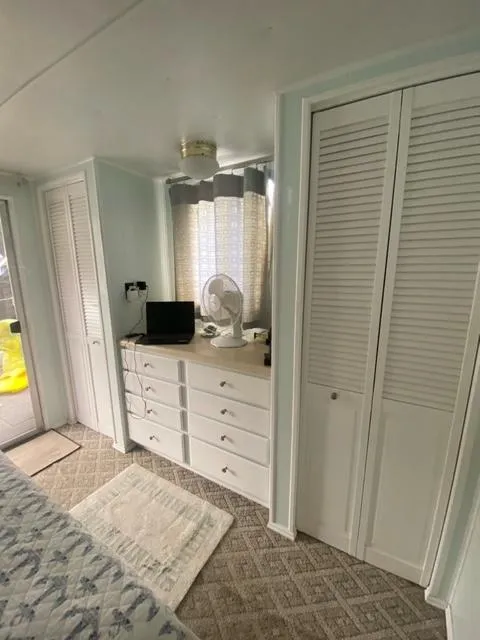 Slide: The Image of Interior of 1985 Arc houseboat with white cabinets and cozy decor. - 7