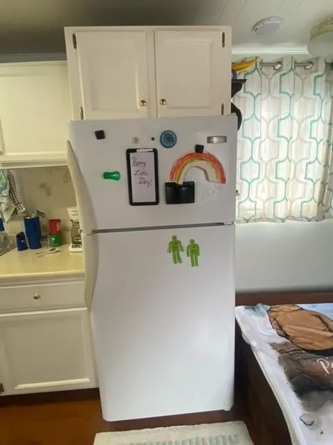 Slide: The Image of Refrigerator in 1985 Arc houseboat kitchen with colorful magnets and decor. - 8