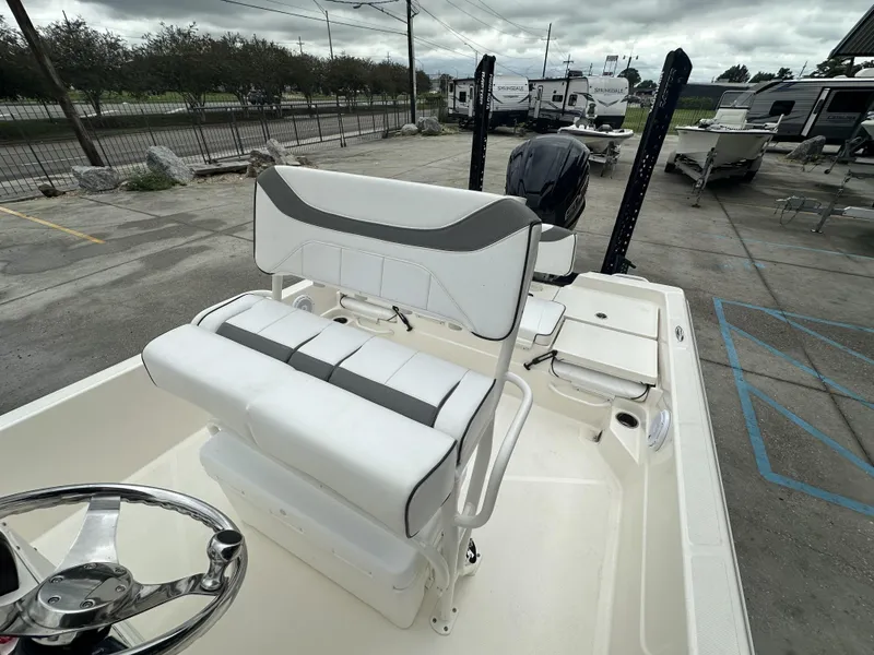 Slide: The Image of 2023 Skeeter SX230 boat interior with white seating and steering wheel. - 10