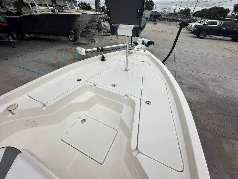 Slide: The Image of 2023 Skeeter SX230 boat deck with storage compartments and trolling motor. - 11