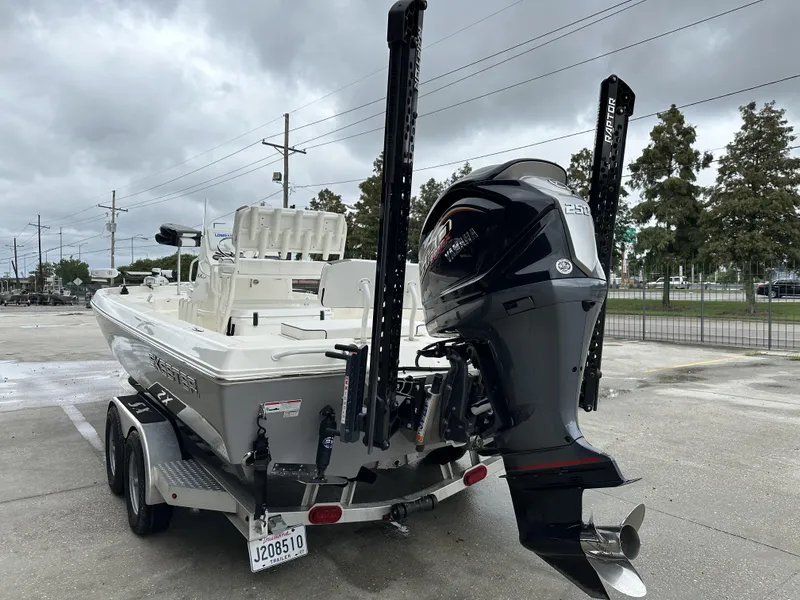 Slide: The Image of 2023 Skeeter SX230 boat on trailer with powerful outboard motor. - 25