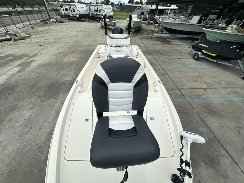 Slide: The Image of 2023 Skeeter SX230 boat with black and white seating, parked in a marina. - 6