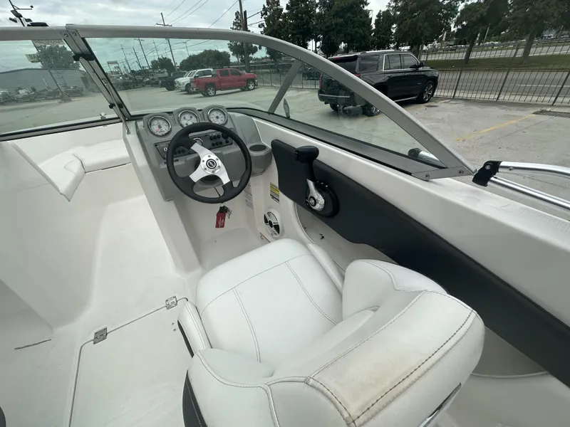 Slide: The Image of Interior view of 2012 Chaparral 18 H2O Sport boat, featuring steering wheel and dashboard. - 12