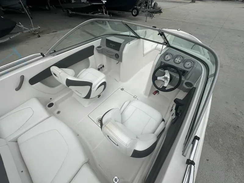 Slide: The Image of Interior of 2012 Chaparral 18 H2O Sport boat with white seating and dashboard. - 4