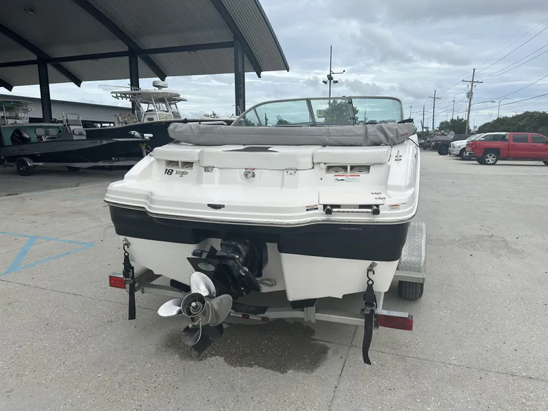 Slide: The Image of 2012 Chaparral 18 H2O Sport boat on trailer, parked outdoors. - 8