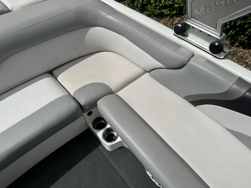 Slide: The Image of Interior of a 2008 MasterCraft X-1 boat with gray and white seating. - 13
