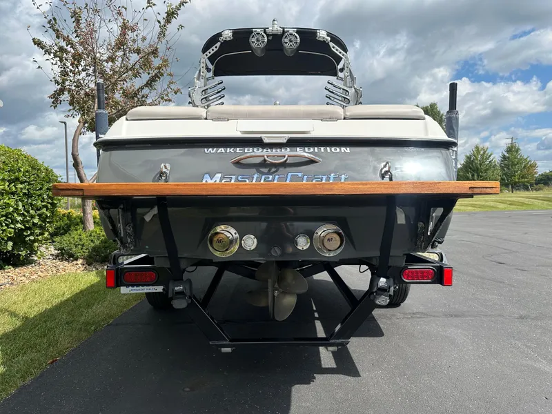 Slide: The Image of Rear view of a 2008 MasterCraft X-1 wakeboard boat on asphalt. - 5