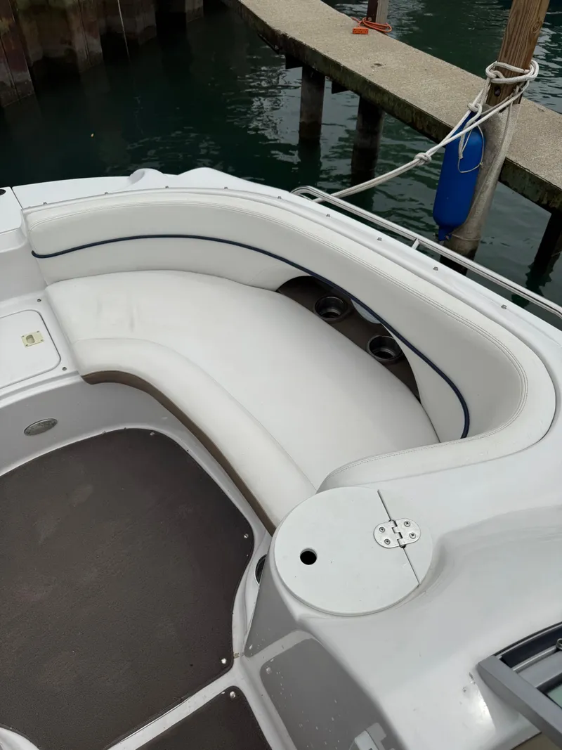 Slide: The Image of 2007 Four Winns 224 Funship boat with white seating, docked by the water. - 13