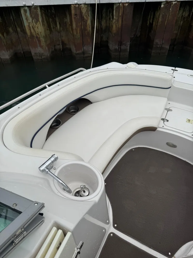 Slide: The Image of 2007 Four Winns 224 Funship boat interior with white seating and cup holder. - 14