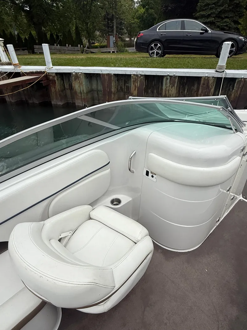 Slide: The Image of 2007 Four Winns 224 Funship boat interior with white seating and glass windshield. - 16