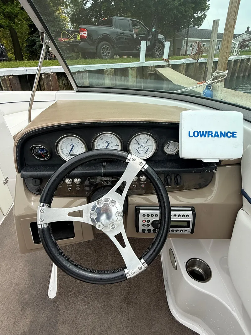 Slide: The Image of 2007 Four Winns 224 Funship boat dashboard with steering wheel and Lowrance navigation system. - 19