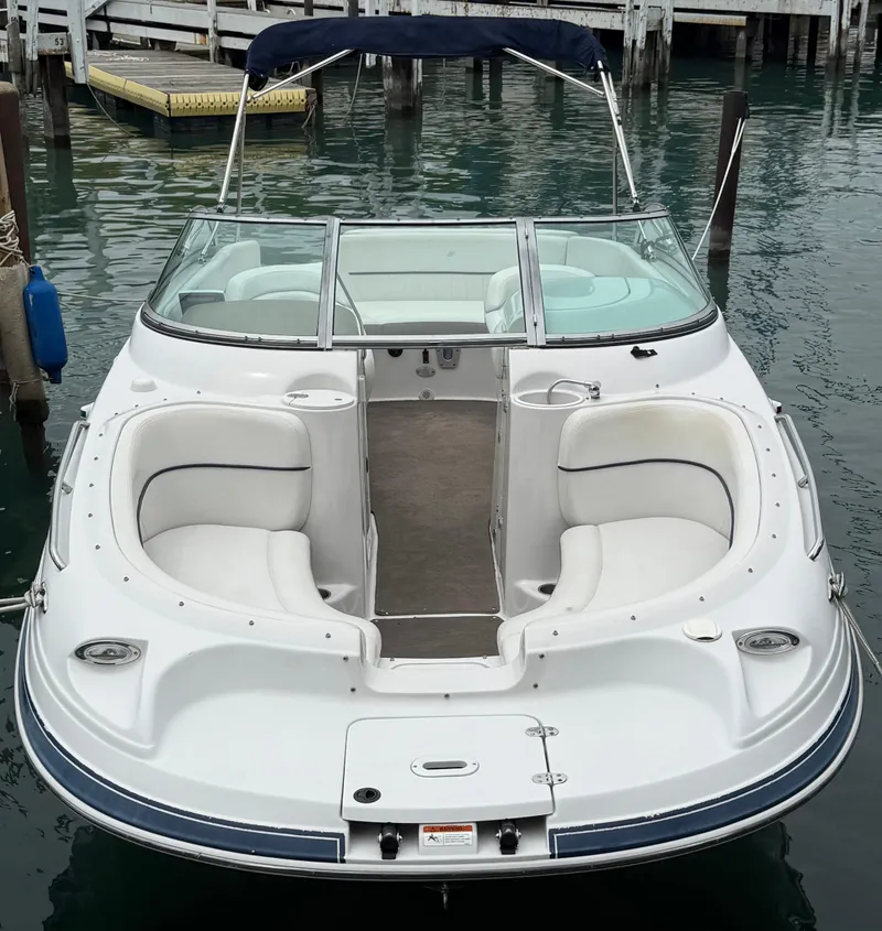 Slide: The Image of 2007 Four Winns 224 Funship boat docked, featuring spacious seating and sleek design. - 2