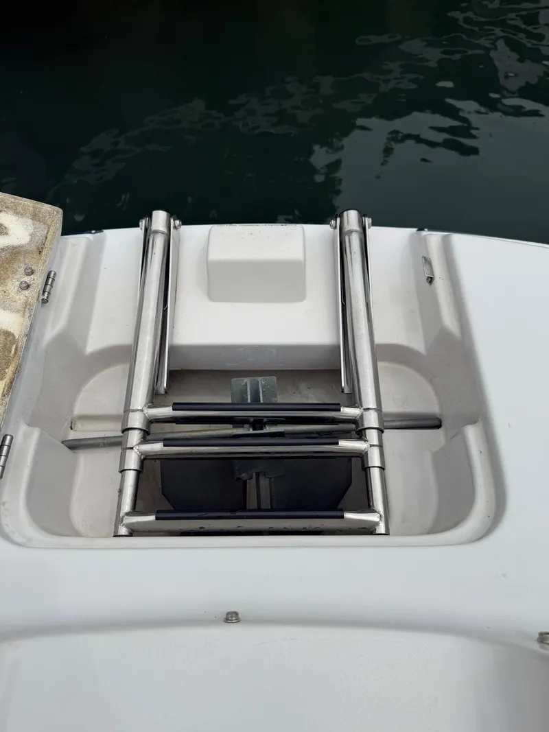 Slide: The Image of 2007 Four Winns 224 Funship boat ladder and platform by the water. - 22