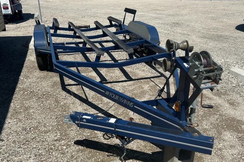 Slide: The Image of 2007 Four Winns 224 Funship boat trailer on gravel surface. - 24