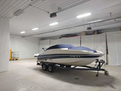 Slide: The Image of 2007 Four Winns 224 Funship boat on trailer in spacious indoor storage. - 26