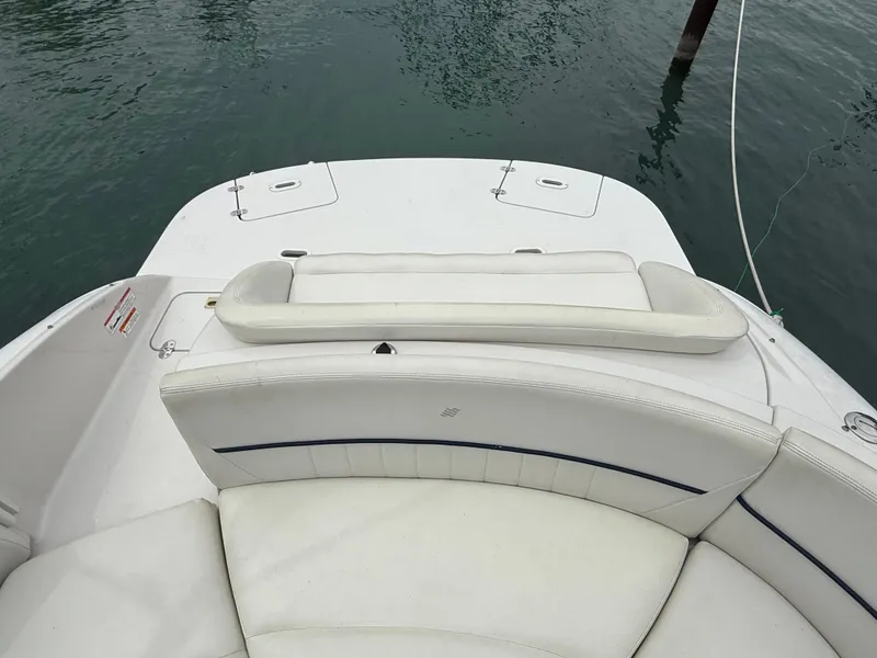 Slide: The Image of 2007 Four Winns 224 Funship boat interior with white seating and water backdrop. - 8