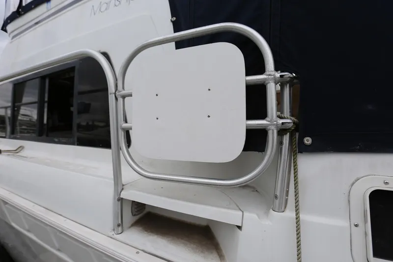 Slide: The Image of 1997 Mainship 34 Motor Yacht side view with railing and window. - 10
