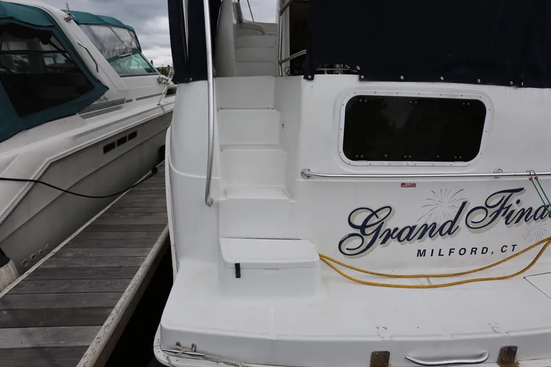Slide: The Image of 1997 Mainship 34 Motor Yacht docked, featuring "Grand Finale" name and Milford, CT location. - 13