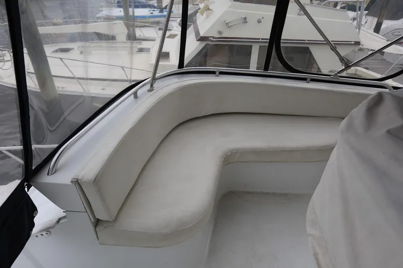 Slide: The Image of 1997 Mainship 34 Motor Yacht with white cushioned seating area on deck. - 14