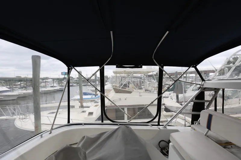 Slide: The Image of 1997 Mainship 34 Motor Yacht interior view with marina background. - 16