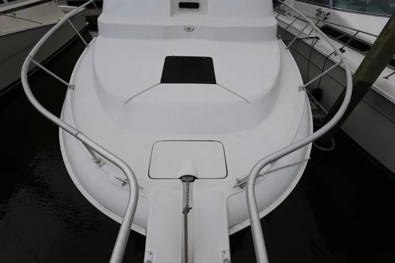Slide: The Image of 1997 Mainship 34 Motor Yacht, white deck view, docked in marina. - 24