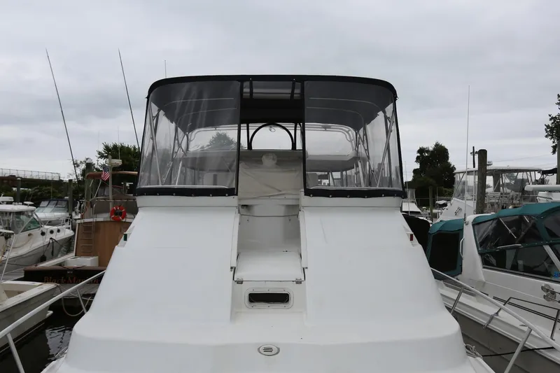Slide: The Image of 1997 Mainship 34 Motor Yacht docked at marina, featuring enclosed flybridge. - 26
