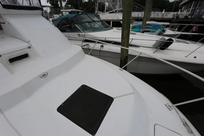 Slide: The Image of 1997 Mainship 34 Motor Yacht docked alongside other boats in a marina. - 28