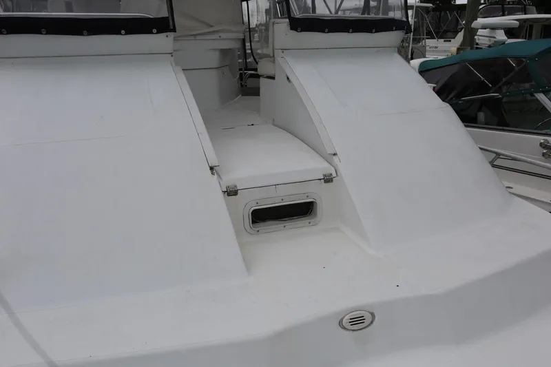 Slide: The Image of 1997 Mainship 34 Motor Yacht deck with white exterior and seating area. - 29