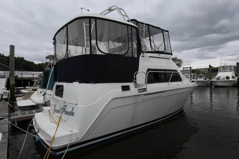 Slide: The Image of 1997 Mainship 34 Motor Yacht docked under cloudy skies. - 3