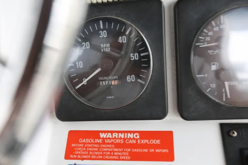 Slide: The Image of Close-up of 1997 Mainship 34 Motor Yacht dashboard with RPM gauge and warning label. - 31