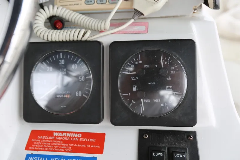 Slide: The Image of 1997 Mainship 34 Motor Yacht dashboard with gauges and warning labels. - 33