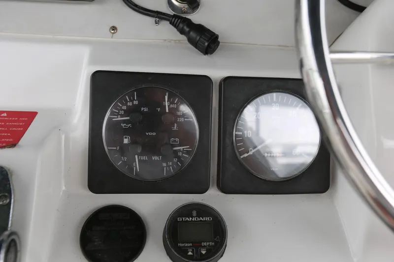 Slide: The Image of Instrument panel of a 1997 Mainship 34 Motor Yacht with gauges and controls. - 34