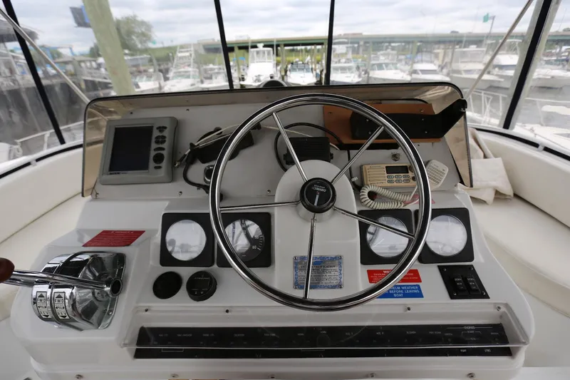 Slide: The Image of 1997 Mainship 34 Motor Yacht helm with steering wheel and navigation instruments. - 35