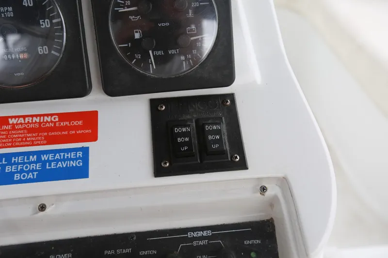 Slide: The Image of Control panel of a 1997 Mainship 34 Motor Yacht with gauges and warning labels. - 37