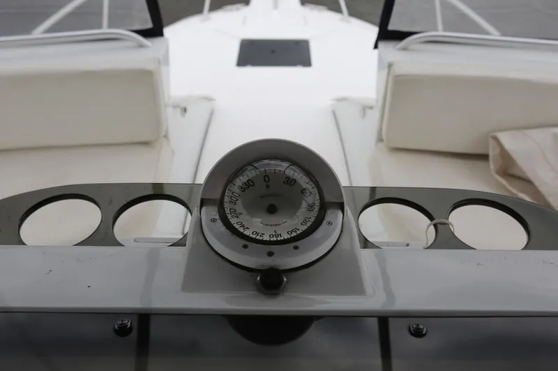 Slide: The Image of 1997 Mainship 34 Motor Yacht dashboard with compass and seating area. - 38