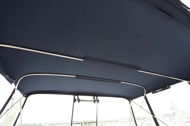 Slide: The Image of 1997 Mainship 34 Motor Yacht canopy with metal supports, viewed from below. - 44