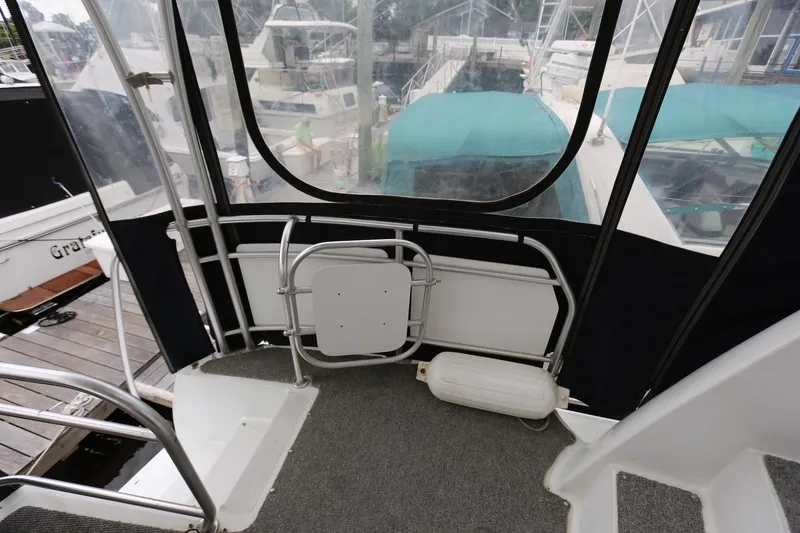 Slide: The Image of 1997 Mainship 34 Motor Yacht deck with railing and marina view. - 48