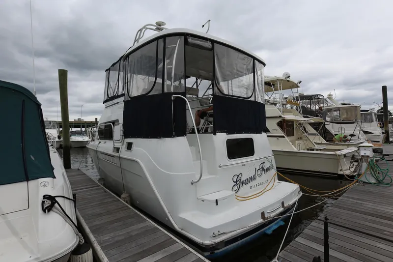 Slide: The Image of 1997 Mainship 34 Motor Yacht docked at marina under cloudy skies. - 5