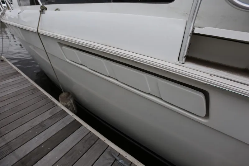 Slide: The Image of 1997 Mainship 34 Motor Yacht docked, showing side view and detailing. - 6