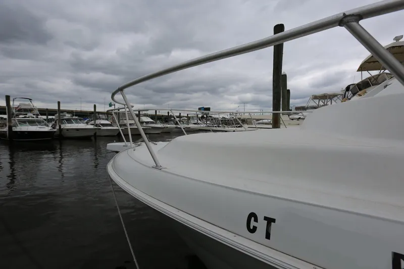 Slide: The Image of 1997 Mainship 34 Motor Yacht docked at marina under cloudy skies. - 7