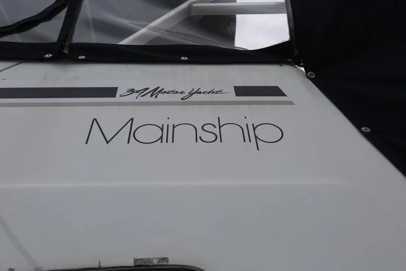 Slide: The Image of 1997 Mainship 34 Motor Yacht branding on boat exterior. - 9